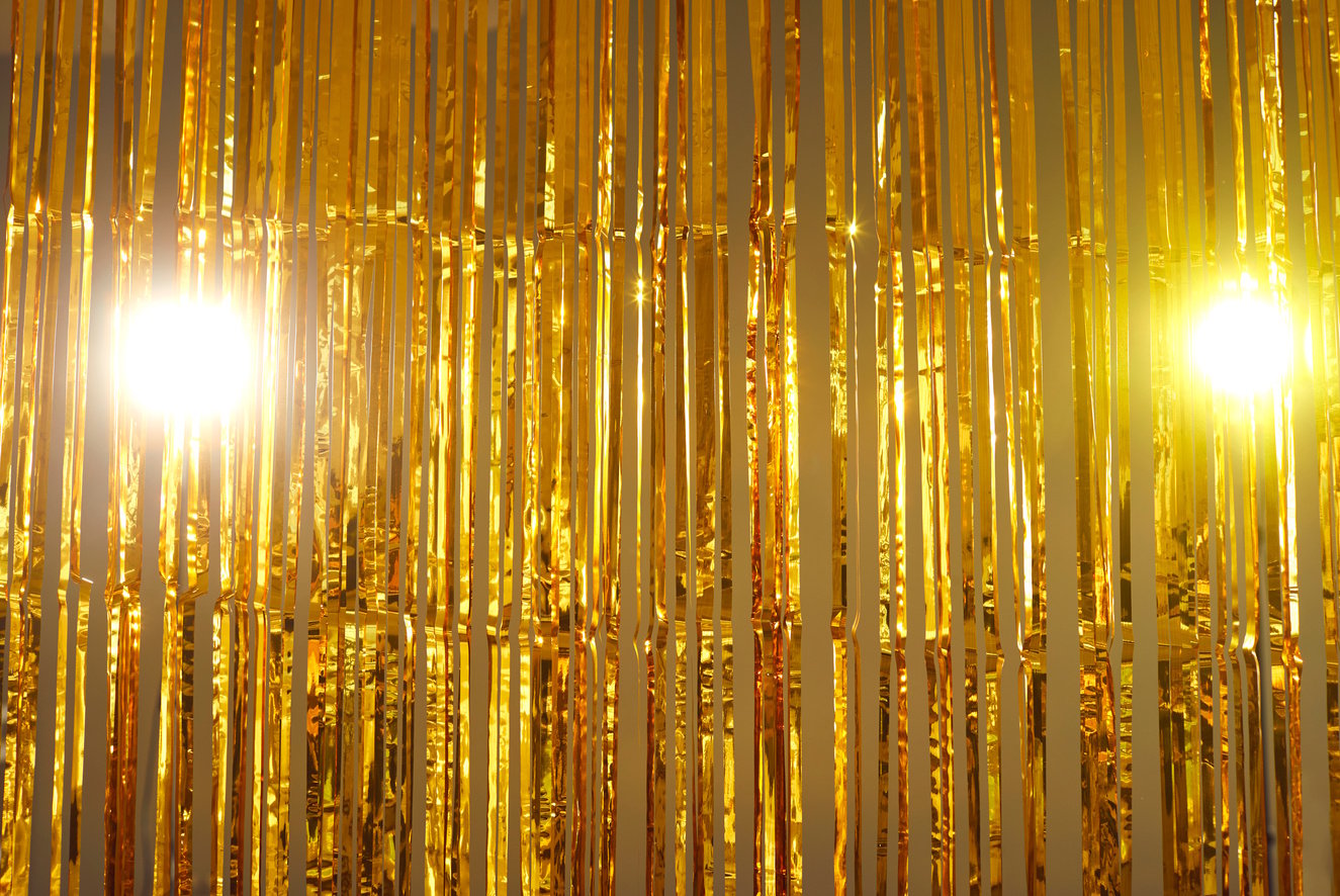 Golden Foil Fringe Curtains Hung as Interior Decor or Backdrop for Photo at a Party